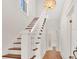 Elegant staircase with wood steps, white risers, and a stylish chandelier creates a grand entrance at 219 Laurel Ave, Sanford, FL 32771