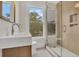 Modern bathroom with glass shower, updated vanity, and a window at 219 Laurel Ave, Sanford, FL 32771