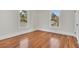 Well-lit bedroom with hardwood floors and two windows at 219 Laurel Ave, Sanford, FL 32771