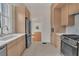 Modern kitchen with stainless steel appliances and light wood cabinets at 219 Laurel Ave, Sanford, FL 32771