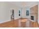 Living room with hardwood floors, fireplace, and view into kitchen at 219 Laurel Ave, Sanford, FL 32771