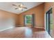 Bedroom with hardwood floors, ceiling fan and backyard view at 2306 Quaker Ct, Orlando, FL 32837