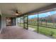 Screened porch overlooking a backyard and lake at 2306 Quaker Ct, Orlando, FL 32837