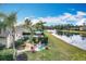 Beautiful backyard featuring a pool, lounge area, and a colorful fire pit next to a scenic pond view at 278 Eaglet Way, Lake Mary, FL 32746