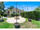 Landscaped backyard features a brick firepit, lush greenery, and string lights, perfect for outdoor entertaining at 278 Eaglet Way, Lake Mary, FL 32746