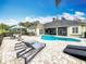 Expansive backyard with a pool, spa, patio, and lounge chairs, creating an oasis for outdoor living at 278 Eaglet Way, Lake Mary, FL 32746