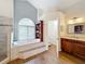 Elegant bathroom featuring a large soaking tub, separate shower, and updated cabinetry at 278 Eaglet Way, Lake Mary, FL 32746