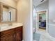 Bathroom with a vanity, toilet, and view into a bedroom and shower at 278 Eaglet Way, Lake Mary, FL 32746