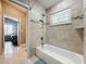 Clean bathroom with a bathtub, shower, and view into a bedroom at 278 Eaglet Way, Lake Mary, FL 32746