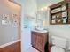 Stylish bathroom showcasing a vanity with vessel sink, wainscoting, and charming decor at 278 Eaglet Way, Lake Mary, FL 32746