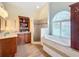 Spa-like bathroom with a soaking tub, walk-in shower, and dual vanity at 278 Eaglet Way, Lake Mary, FL 32746