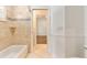 Bright bathroom featuring tiled walls, shower, white fixtures, and an open doorway at 278 Eaglet Way, Lake Mary, FL 32746