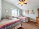 Bright bedroom with two twin beds and wood flooring at 278 Eaglet Way, Lake Mary, FL 32746