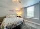 Bright bedroom with a queen bed and window seat at 278 Eaglet Way, Lake Mary, FL 32746