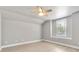 Light and airy bedroom with a ceiling fan, light gray walls, and a window providing natural light at 278 Eaglet Way, Lake Mary, FL 32746