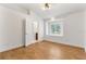Light and airy bedroom with wood floors, shuttered window, and a doorway to an ensuite at 278 Eaglet Way, Lake Mary, FL 32746