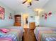 Spacious bedroom with two twin beds, wood-look floors, and plenty of natural light at 278 Eaglet Way, Lake Mary, FL 32746
