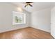 Bright bedroom featuring wood floors, white walls, shuttered window, and ceiling fan at 278 Eaglet Way, Lake Mary, FL 32746