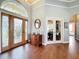 Bright entry with wood floors, double doors, and a charming console table at 278 Eaglet Way, Lake Mary, FL 32746