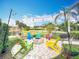 Charming backyard fire pit with colorful Adirondack chairs, perfect for cozy evenings outdoors at 278 Eaglet Way, Lake Mary, FL 32746