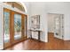 Bright foyer featuring a decorative glass front door, wood floors, and elegant console table with art at 278 Eaglet Way, Lake Mary, FL 32746