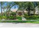 Charming front exterior with lush landscaping and inviting entrance with arched doorway at 278 Eaglet Way, Lake Mary, FL 32746
