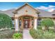 Inviting home exterior featuring a beautifully landscaped yard and a charming entryway with columns at 278 Eaglet Way, Lake Mary, FL 32746