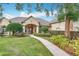 Charming home exterior featuring lush landscaping, mature trees, and a welcoming walkway at 278 Eaglet Way, Lake Mary, FL 32746