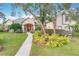 Beautiful home with lush landscaping, mature trees, and a walkway to the arched front entryway at 278 Eaglet Way, Lake Mary, FL 32746