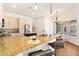 Open kitchen with granite countertops, stainless steel appliances, breakfast bar, and adjacent dining area at 278 Eaglet Way, Lake Mary, FL 32746