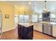 Spacious kitchen featuring a granite island and warm wood cabinets at 278 Eaglet Way, Lake Mary, FL 32746
