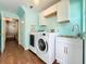 Laundry room with washer, dryer, cabinets, and access to the hallway at 278 Eaglet Way, Lake Mary, FL 32746