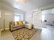 Inviting living room with a comfortable sectional sofa, stylish rug, and unique sliding barn door at 278 Eaglet Way, Lake Mary, FL 32746