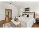 Serene main bedroom with an upholstered headboard, bench, decorative pillows, and ensuite access at 278 Eaglet Way, Lake Mary, FL 32746
