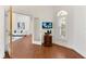 Corner office with wood floors, shuttered window, small dark wood cabinet, and glass panel doors at 278 Eaglet Way, Lake Mary, FL 32746