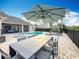 Outdoor dining area with patio table and umbrella at 278 Eaglet Way, Lake Mary, FL 32746