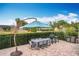 Outdoor patio with dining furniture, umbrella, and grill at 278 Eaglet Way, Lake Mary, FL 32746