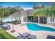 Aerial view of the backyard featuring a sparkling pool, spa, patio furniture, and lush landscaping at 278 Eaglet Way, Lake Mary, FL 32746