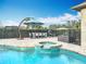 Stunning pool and spa area with an umbrella, dining table, and grill, ideal for backyard gatherings at 278 Eaglet Way, Lake Mary, FL 32746