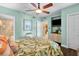 Bright bedroom with a leafy comforter and access to the bathroom at 2901 S Atlantic Ave # 702, Daytona Beach, FL 32118