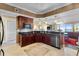 Modern kitchen with dark wood cabinets, granite counters, and stainless steel appliances at 2901 S Atlantic Ave # 702, Daytona Beach, FL 32118