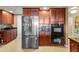 Kitchen with stainless steel appliances and dark wood cabinets at 2901 S Atlantic Ave # 702, Daytona Beach, FL 32118