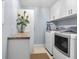 Convenient laundry room with washer, dryer, and folding counter at 2901 S Atlantic Ave # 702, Daytona Beach, FL 32118