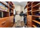 A spacious walk-in closet featuring custom wood shelving and ample storage for clothes, shoes and accessories at 2901 S Atlantic Ave # 702, Daytona Beach, FL 32118