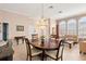 Spacious dining room with a crystal chandelier and dark wood table at 3413 Foxcroft Cir, Oviedo, FL 32765