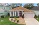 One-story home with a brown roof, beige walls, and landscaped yard at 3413 Foxcroft Cir, Oviedo, FL 32765