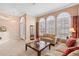 Bright living room with neutral colored sofas and a large glass coffee table at 3413 Foxcroft Cir, Oviedo, FL 32765