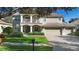 Two-story house with a three-car garage and manicured lawn at 346 Calliope St, Ocoee, FL 34761