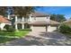Two-story home with a three-car garage and manicured lawn at 346 Calliope St, Ocoee, FL 34761