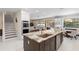 Open kitchen with island, stainless steel appliances, and granite countertops at 346 Calliope St, Ocoee, FL 34761